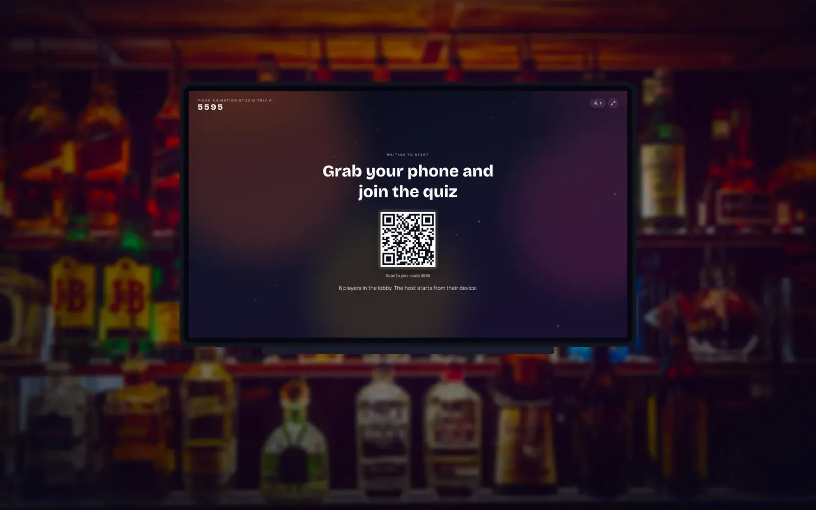 A bar interior with a television showing a GozQuiz lobby, a 4-digit join code, and a QR code.